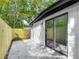 Concrete back patio with a wooden fence and sliding glass doors for natural light at 102 Judges Ln, Port Orange, FL 32129