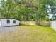 Spacious backyard with a large tree and a newly installed wooden fence offering privacy at 102 Judges Ln, Port Orange, FL 32129
