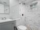 Bathroom featuring a modern vanity, toilet, and tiled shower at 102 Judges Ln, Port Orange, FL 32129