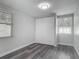 Bedroom featuring gray plank flooring, a closet, and two windows at 102 Judges Ln, Port Orange, FL 32129