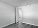 Bedroom featuring modern gray plank flooring and a doorway to another room at 102 Judges Ln, Port Orange, FL 32129