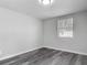Bright bedroom with grey laminate flooring and a window providing natural light at 102 Judges Ln, Port Orange, FL 32129
