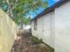 Exterior side view of the house with a wood fence and gate access at 102 Judges Ln, Port Orange, FL 32129