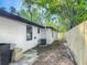 Exterior side view of the home and the side yard with wood fence at 102 Judges Ln, Port Orange, FL 32129