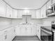 Well-lit kitchen featuring modern appliances, a subway tile backsplash, and bright white cabinetry at 102 Judges Ln, Port Orange, FL 32129