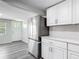 Kitchen with stainless steel fridge and subway tile, leading to entrance at 102 Judges Ln, Port Orange, FL 32129