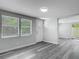 Bright living room with stylish gray floors and natural light, freshly painted for modern appeal at 102 Judges Ln, Port Orange, FL 32129