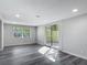 Living room featuring modern gray plank flooring and a sliding glass door to the back patio at 102 Judges Ln, Port Orange, FL 32129
