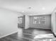 Bright living room with modern gray plank flooring and a sliding glass door at 102 Judges Ln, Port Orange, FL 32129