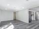 Spacious, open-concept living room with recessed lighting, grey wood floors, and an open floorplan at 102 Judges Ln, Port Orange, FL 32129