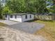 Angle view of a well-maintained yard with a newly fenced area and a gray gravel area at 102 Judges Ln, Port Orange, FL 32129