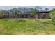 Spacious backyard with manicured lawn, pool enclosure, and mature trees at 104 Balmoral Ct, Debary, FL 32713