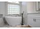 Modern bathroom showcasing a freestanding tub with marble accents and a stylish faucet at 104 Balmoral Ct, Debary, FL 32713
