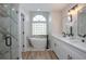 Elegant bathroom with a freestanding tub, dual vanities, and a glass-enclosed shower at 104 Balmoral Ct, Debary, FL 32713