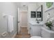 Stylish bathroom featuring a modern vanity, black fixtures, and wood-look flooring at 104 Balmoral Ct, Debary, FL 32713