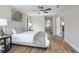 Cozy bedroom with wood-look floors, a queen-size bed, and calming neutral tones at 104 Balmoral Ct, Debary, FL 32713
