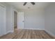 Bright bedroom featuring light-colored walls, wood-look flooring, and ceiling fan at 104 Balmoral Ct, Debary, FL 32713