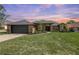 Charming brick home with a well-manicured lawn and professional landscaping, with an attached two-car garage at 104 Balmoral Ct, Debary, FL 32713