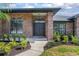 Inviting home entrance featuring a double door, brick accents, and manicured landscaping at 104 Balmoral Ct, Debary, FL 32713