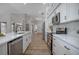 Modern kitchen featuring white cabinets, stainless steel appliances, and a stylish backsplash at 104 Balmoral Ct, Debary, FL 32713