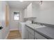 Well-lit laundry room equipped with modern appliances, sink, and ample storage at 104 Balmoral Ct, Debary, FL 32713