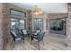 Covered patio area with brick accents, outdoor seating, and view to the pool at 104 Balmoral Ct, Debary, FL 32713