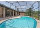 Sparkling pool with screened enclosure, patio area, and lush landscaping at 104 Balmoral Ct, Debary, FL 32713