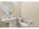 Cozy half bathroom featuring a pedestal sink and a toilet at 109 Fern Springs St, Debary, FL 32713