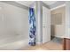 Bathroom with tile flooring, shower with curtain, and white door at 109 Fern Springs St, Debary, FL 32713