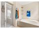 Bright bathroom featuring a glass shower, soaking tub, neutral tones, and wall shelving at 109 Fern Springs St, Debary, FL 32713