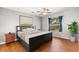 Comfortable bedroom with wood floors, a ceiling fan, and natural light from the window at 109 Fern Springs St, Debary, FL 32713