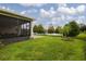 Spacious backyard featuring lush green lawn, screened porch and serene lake views at 1118 Avery Meadows Way, Deland, FL 32724