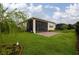 Well-manicured backyard with a screened porch, brick patio, and black metal fence at 1118 Avery Meadows Way, Deland, FL 32724