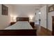 Well-lit bedroom with hardwood floors, nightstands and a queen bed at 1118 Avery Meadows Way, Deland, FL 32724