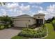Charming single-story home with a brick driveway, well manicured lawn and colorful landscaping at 1118 Avery Meadows Way, Deland, FL 32724