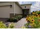 Well-maintained front yard with walkway and colorful flowers leading to the charming single story home at 1118 Avery Meadows Way, Deland, FL 32724
