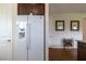 Bright kitchen with stainless refrigerator, adjacent to a wine rack and decorative wall art at 1118 Avery Meadows Way, Deland, FL 32724