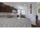 Bright kitchen with granite countertops, dark cabinetry, and stainless steel appliances at 1118 Avery Meadows Way, Deland, FL 32724