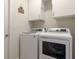 Functional laundry room with white appliances and storage cabinets at 1118 Avery Meadows Way, Deland, FL 32724