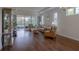 Open-concept living room with wood floors, large windows, and a view of the screened-in lanai at 1118 Avery Meadows Way, Deland, FL 32724