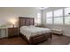 Comfortable main bedroom with wood floors, bright windows, and elegant furnishings at 1118 Avery Meadows Way, Deland, FL 32724