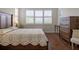 Comfortable main bedroom with wood floors, bright windows, and elegant furnishings at 1118 Avery Meadows Way, Deland, FL 32724
