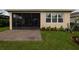 The property features a screened porch with a brick patio and beautiful lawn at 1118 Avery Meadows Way, Deland, FL 32724