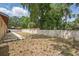 Spacious backyard bordered by a concrete block wall and lush green trees at 1209 James Ter, Daytona Beach, FL 32117