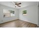 Bright bedroom featuring neutral walls, modern ceiling fan and wood-look laminate flooring at 1209 James Ter, Daytona Beach, FL 32117