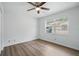 Bright bedroom featuring neutral walls, modern ceiling fan and wood-look laminate flooring at 1209 James Ter, Daytona Beach, FL 32117