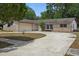 Charming single-story home featuring a stone facade and a two-car garage at 1209 James Ter, Daytona Beach, FL 32117