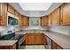 Well-maintained kitchen featuring wood cabinets, stainless appliances, and granite countertops at 1209 James Ter, Daytona Beach, FL 32117