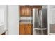 This kitchen features stainless steel refrigerator and matching wooden cabinets at 1209 James Ter, Daytona Beach, FL 32117
