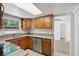 This kitchen features wood cabinets, stainless steel appliances, and stone countertops at 1209 James Ter, Daytona Beach, FL 32117